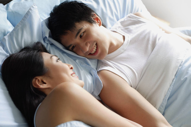 happy Couple in bedroom - Фото, изображение