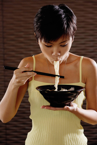 woman eating noodles - Photo, image