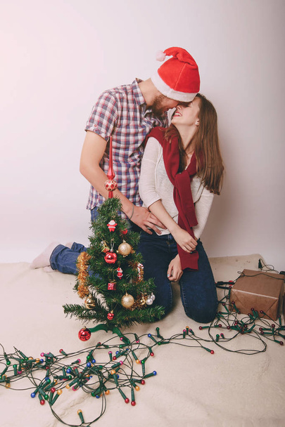 loving couple decorating Christmas tree - Foto, Imagen