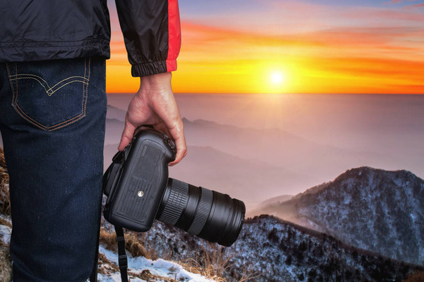 professioneller Fotograf mit Kamera bei Sonnenuntergang. - Foto, Bild