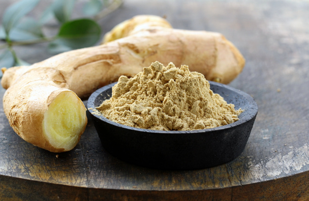 Ground ginger (spice) and fresh on a wooden board - Photo, Image