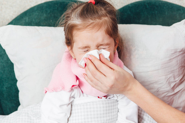 little girl with flu blowing nose - Фото, зображення