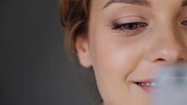 face of smiling woman with smartphone - Video, Çekim
