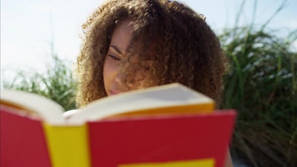 female reading a book - Felvétel, videó