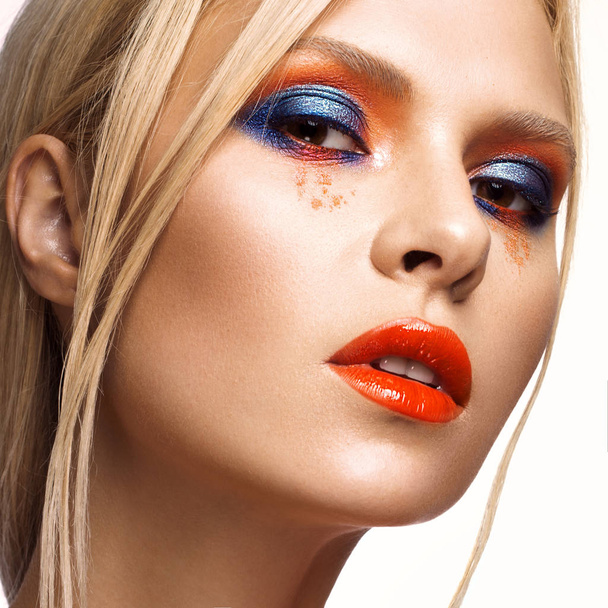 Beautiful girl with bright colored makeup and orange lips. Beauty face. - Valokuva, kuva