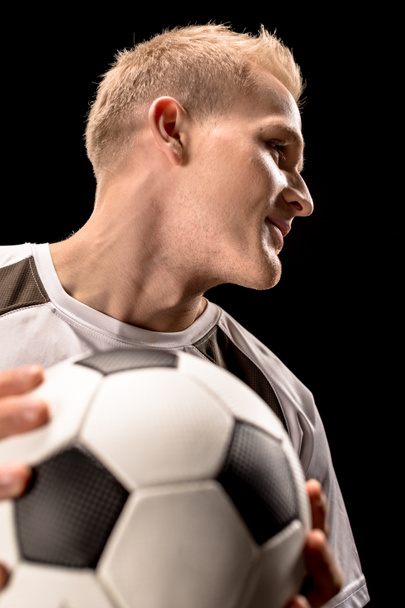 Soccer player holding ball - Фото, зображення
