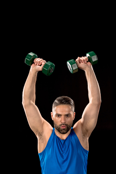 Sportive man with dumbbells - Photo, image
