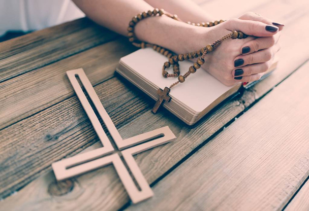 Womans hands with wooden rosary and Holy Bible - Foto, Imagem