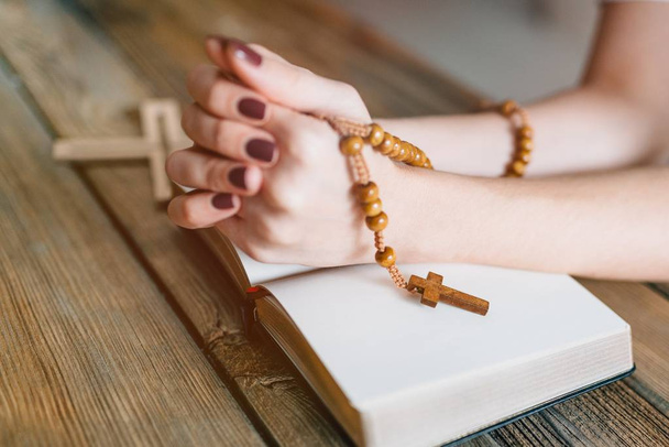 Womans hands with wooden rosary and Holy Bible - Photo, Image