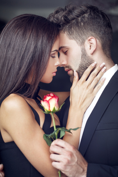 Young man give rose to lover indoor - Photo, Image