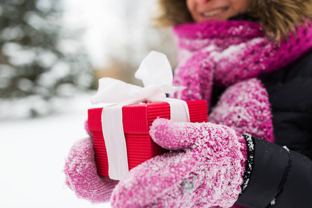 close up of woman with christmas gift outdoors - Photo, Image