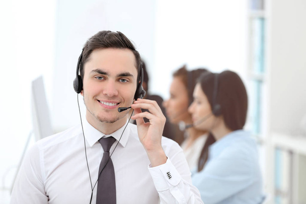Male call center operator working in office - Foto, Imagen