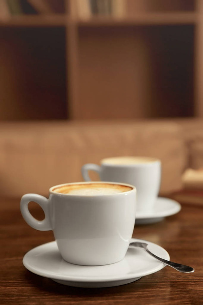 Cup of coffee on table - Fotó, kép