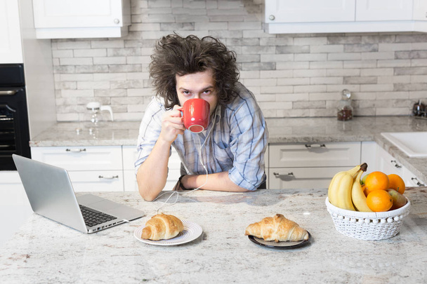 Man Eating Breakfast during Using Laptop - Photo, Image