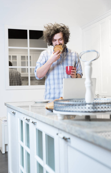 Man Eating Breakfast during Using Laptop - Photo, image
