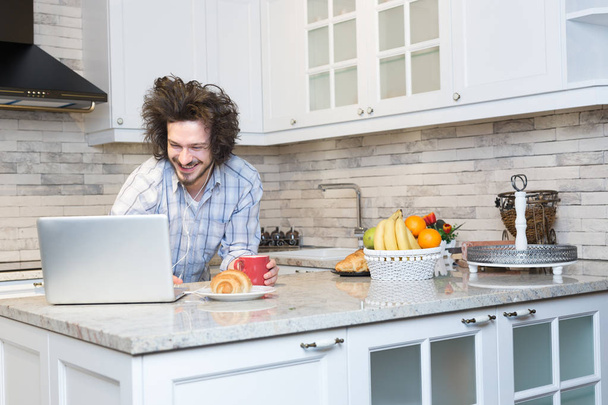 Man Eating Breakfast during Using Laptop - Фото, изображение