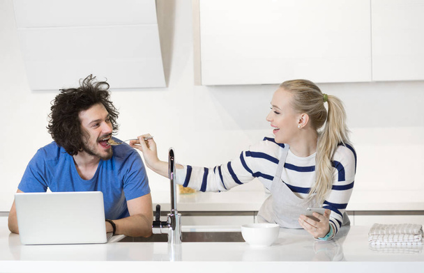 Beautiful young couple in kitchen - Foto, Imagem