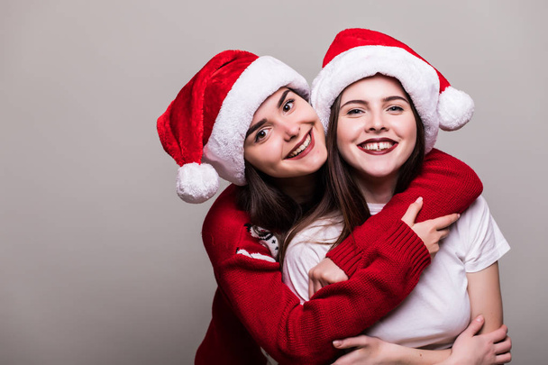 Two teenegers girls in santa hat  - Photo, Image