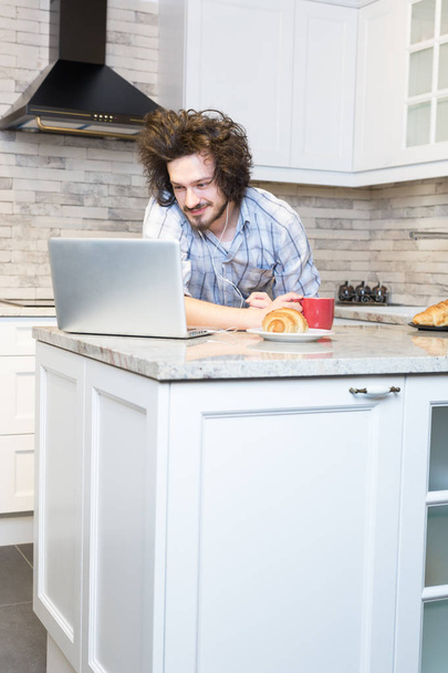 Man Eating Breakfast during Using Laptop - Foto, Bild