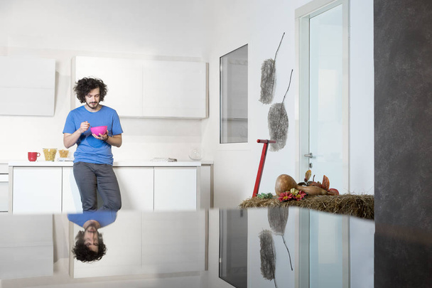 Man eating cereal in kitchen - Photo, Image