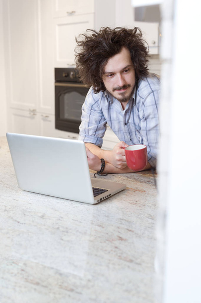Man Eating Breakfast during Using Laptop - Photo, image