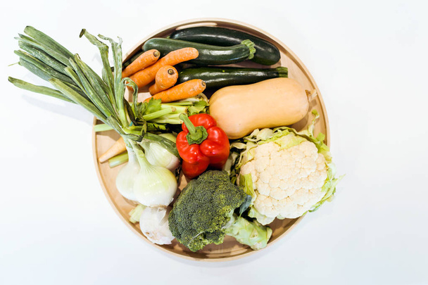 Plate of fresh vegetables under white background. - Fotó, kép