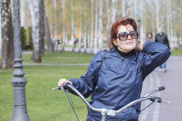 Tandem bicycle. Aged woman. Active lifestyle - Photo, Image
