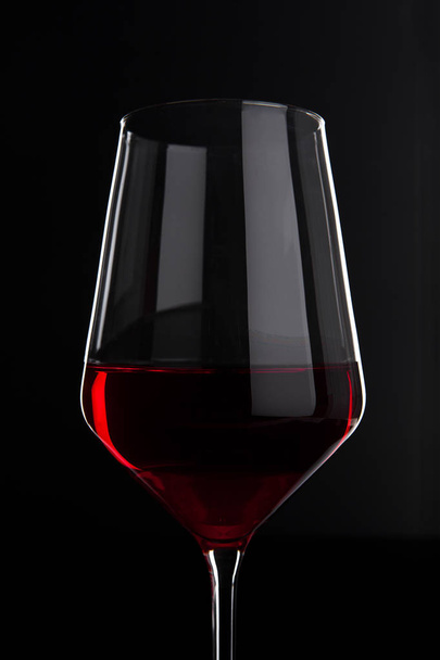 Glass of red wine with reflection on black - Φωτογραφία, εικόνα
