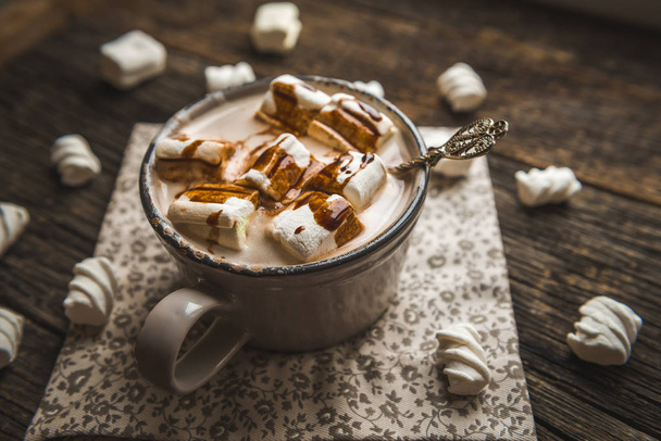 Hot cocoa with marshmallows spices on the old wooden boards. - 写真・画像