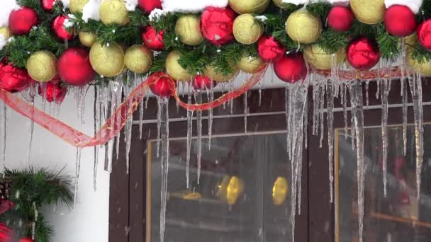 Christmas toy decorations covered with icicle and snow. Blizzard snow falling - Footage, Video