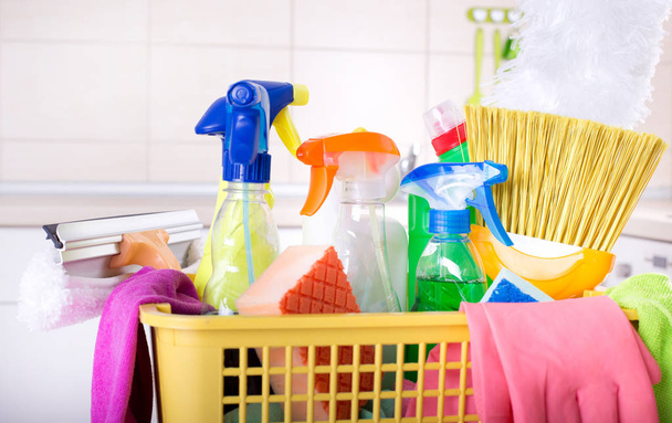 Cleaning supplies in basket in kitchen - Photo, Image