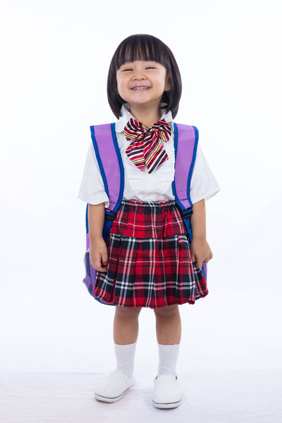 Asian Chinese little girl wearing student uniform and school bag - 写真・画像