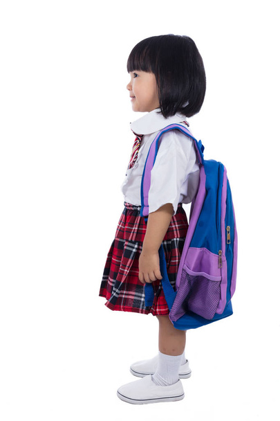 Asian Chinese little girl wearing student uniform and school bag - 写真・画像