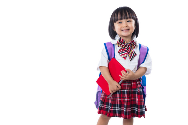 Asian Chinese little student girl with school bag and books - 写真・画像