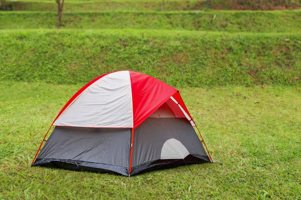 Tienda cúpula roja sobre hierba verde en camping
 - Foto, imagen