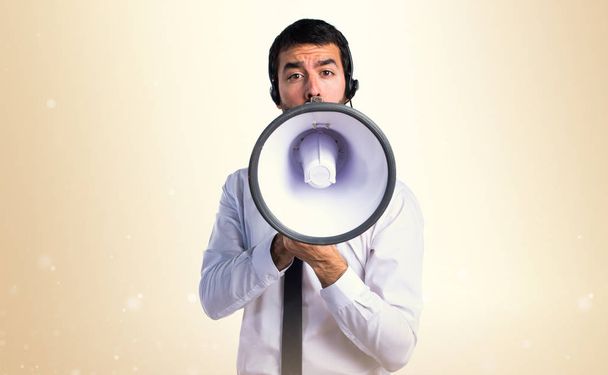 Handsome telemarketer man shouting by megaphone - Photo, image