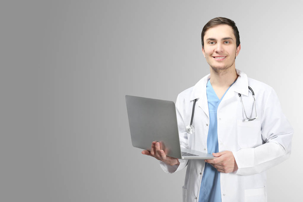 Young doctor with laptop - Φωτογραφία, εικόνα
