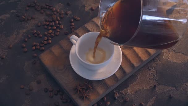 cup of black coffee and beans over grunge wooden table - Materiał filmowy, wideo