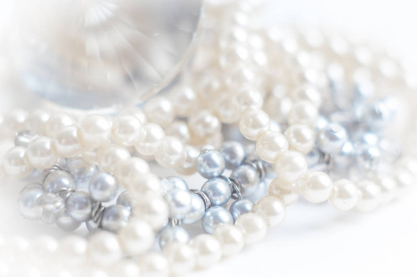 Abstract blurred background, pearl necklace on white. Macro shot, Shallow depth of field, defocused - Photo, Image