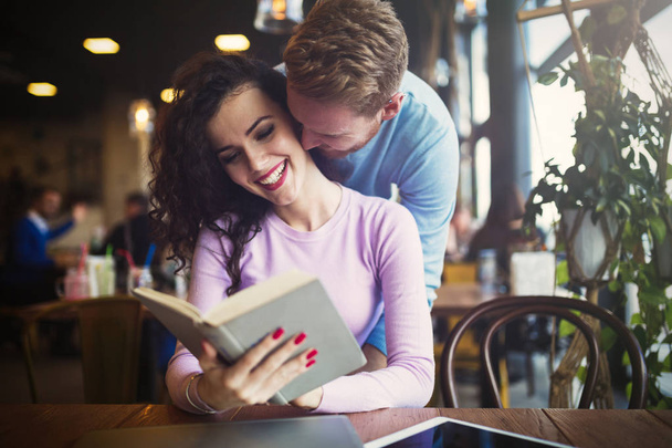 Happy couple studying in library - Zdjęcie, obraz