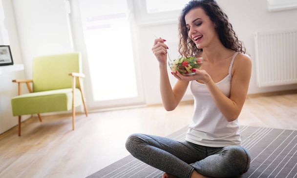Beautiful woman eating healthy fresh food - Photo, image