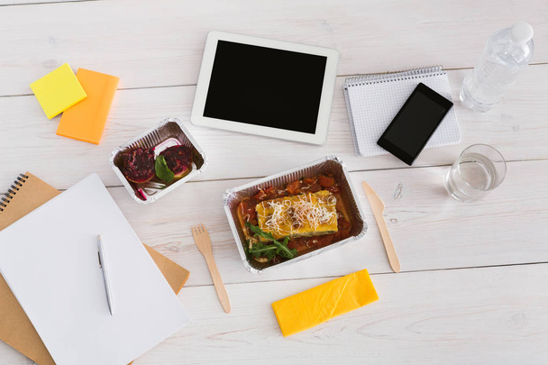 Healthy lunch foil box with diet food on office table - Photo, Image