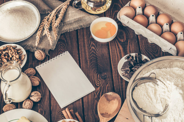 ingredients for baking homemade cake on vintage wooden kitchen table background. - 写真・画像