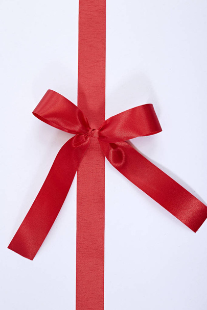 red gift satin ribbon bow on white background - Фото, изображение