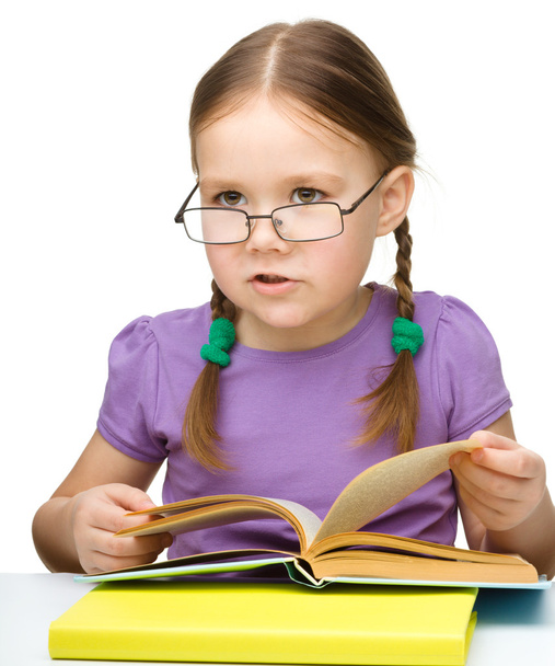 Cute little girl reading book wearing glasses - Fotoğraf, Görsel