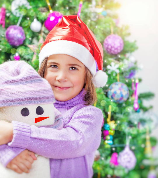 Little girl with snowman toy - Fotó, kép