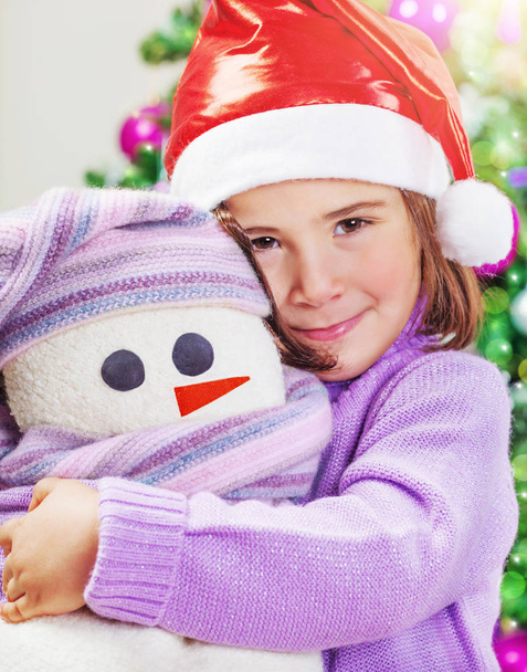Cute girl with snowman toy - Photo, Image
