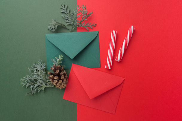 Red and green envelopes on christmas holiday background. Flat lay. - Фото, зображення
