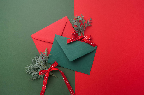 Red and green envelopes on christmas holiday background. Flat lay. - Photo, image