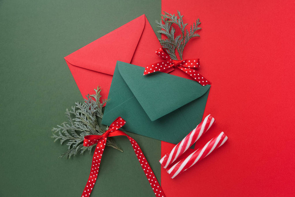 Red and green envelopes on christmas holiday background. Flat lay. - Valokuva, kuva